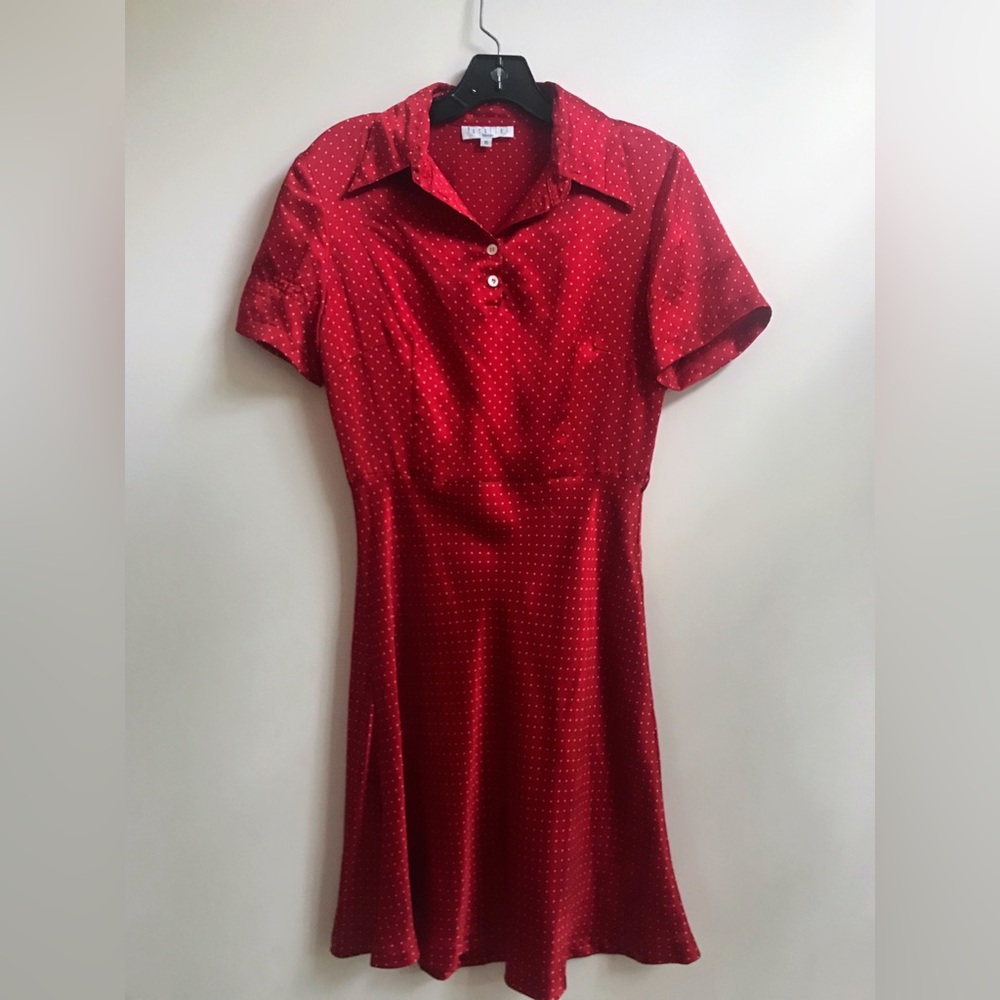 Red silk like shirt dress with small white polka dots.